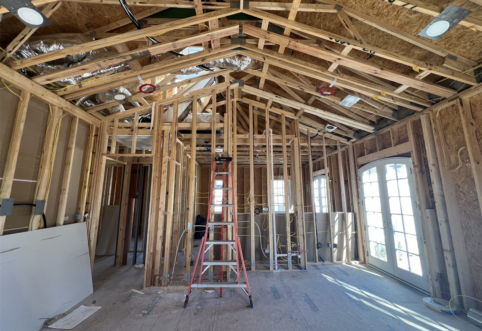 Interior room framing with exposed rafters and ladder